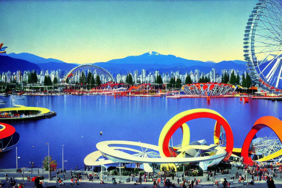 Colorful park with Ferris wheel, red sculptures, and mountain backdrop.