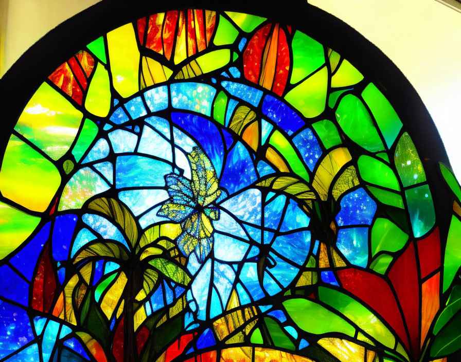 Colorful stained glass window with bird and foliage motif