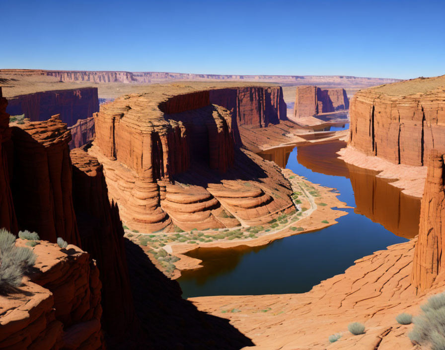 Scenic horseshoe-shaped river bend with orange cliffs under blue sky