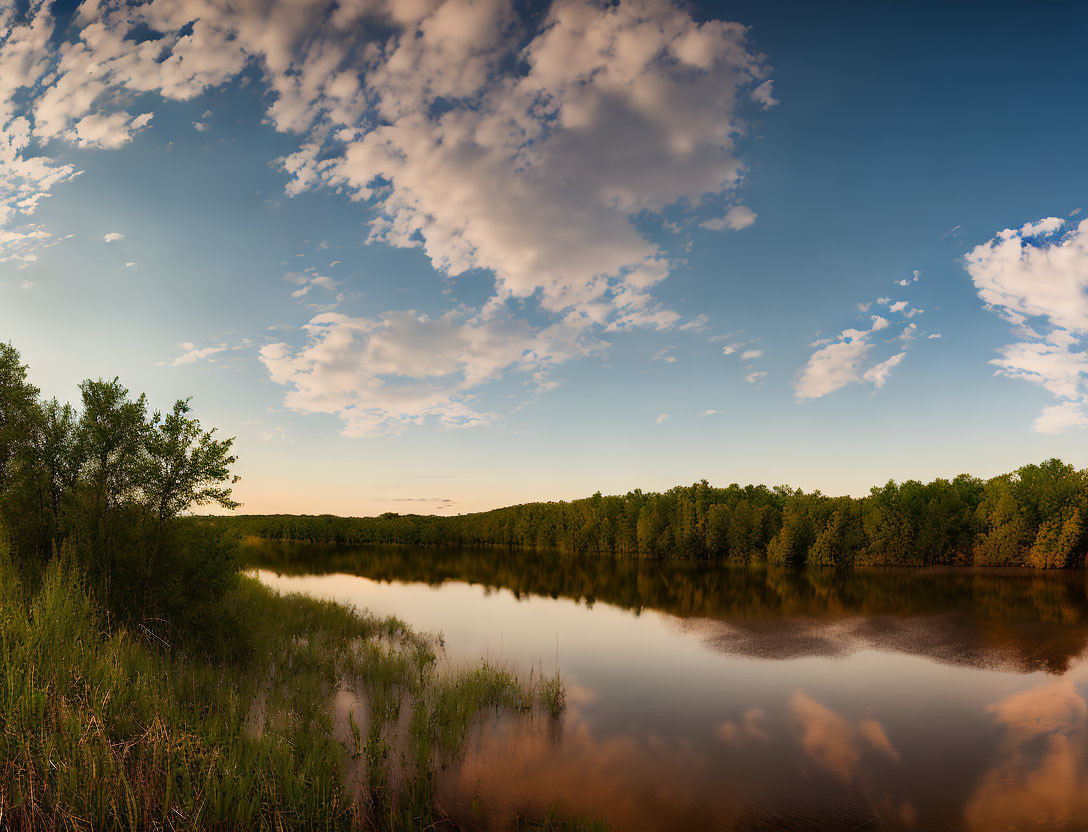 Tranquil river scene with lush trees and golden hour sky