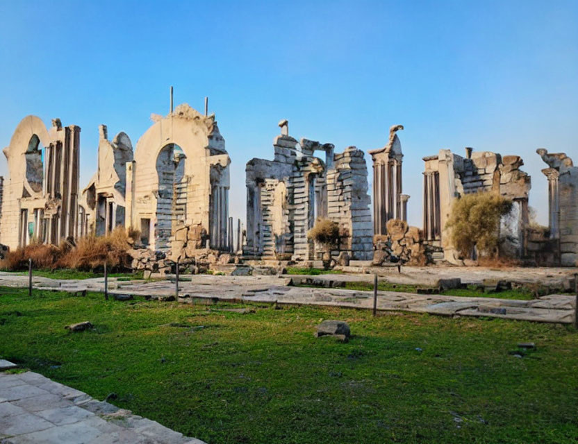 Ancient structure ruins with columns and architraves under clear blue sky