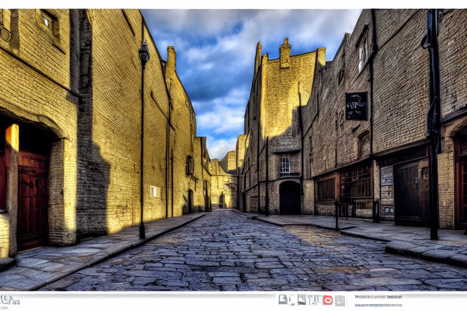 Historical cobblestone street and old brick buildings under clear blue sky