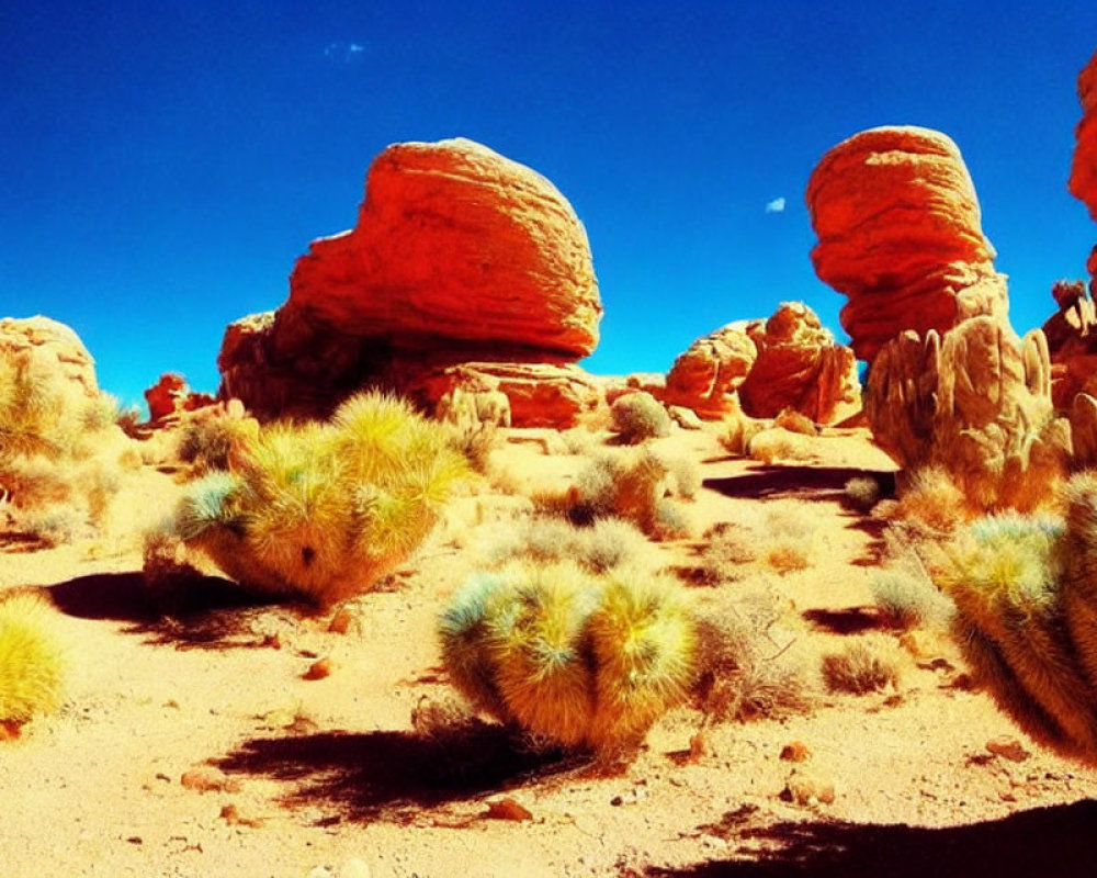 Red Desert Landscape with Towering Rock Formations and Blue Sky