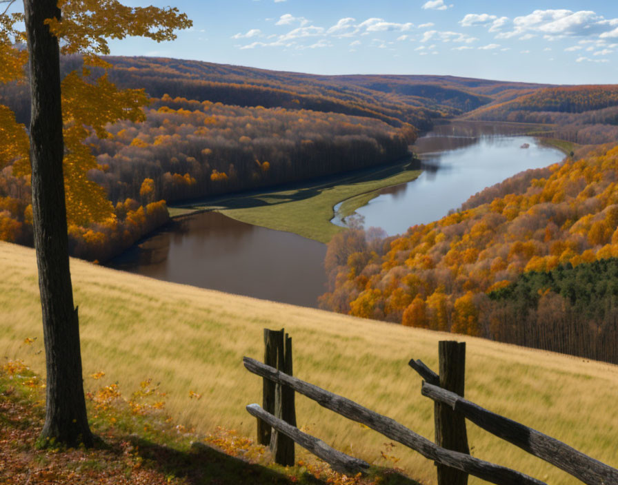 Tranquil autumn river landscape with fall foliage and wooden fence