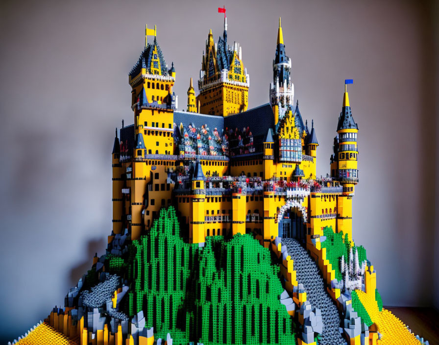 Colorful Lego Castle with Towers and Ramparts on Green Brick Base