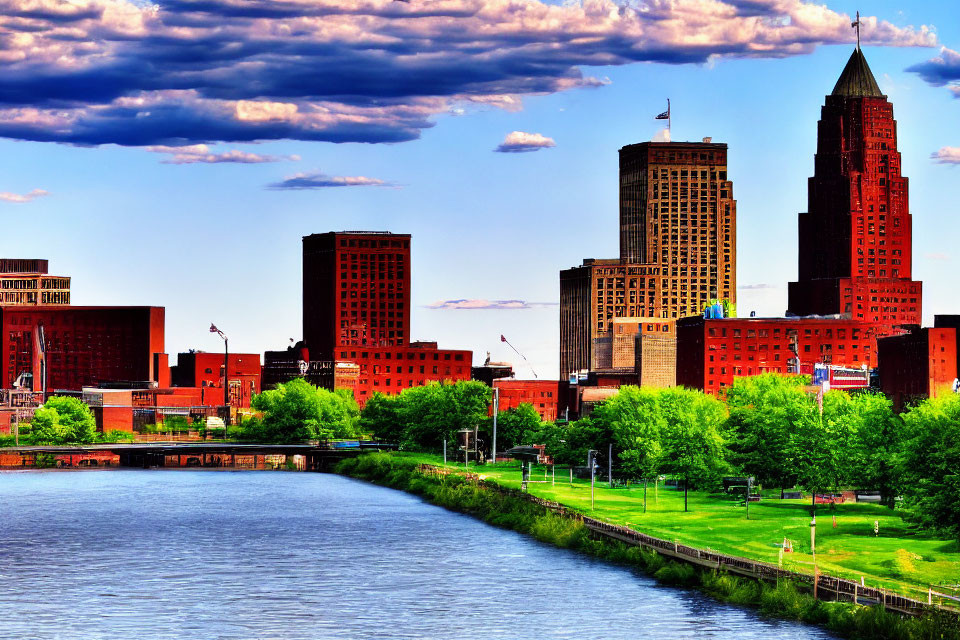 Cityscape with skyscrapers, river, greenery, and blue sky