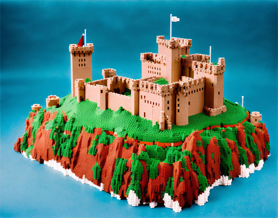 Detailed LEGO castle with multiple towers and ramparts on green hill