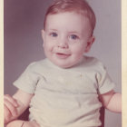 Cherubic child with curly hair holding patterned fabric in vintage style