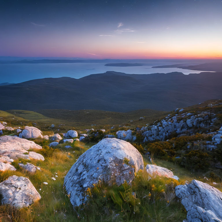 Tranquil landscape with twilight hues, gradient sky, rocks, hills, and calm sea