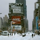 City street in winter with pedestrians, cars, street lamps, snow, and skyscrapers