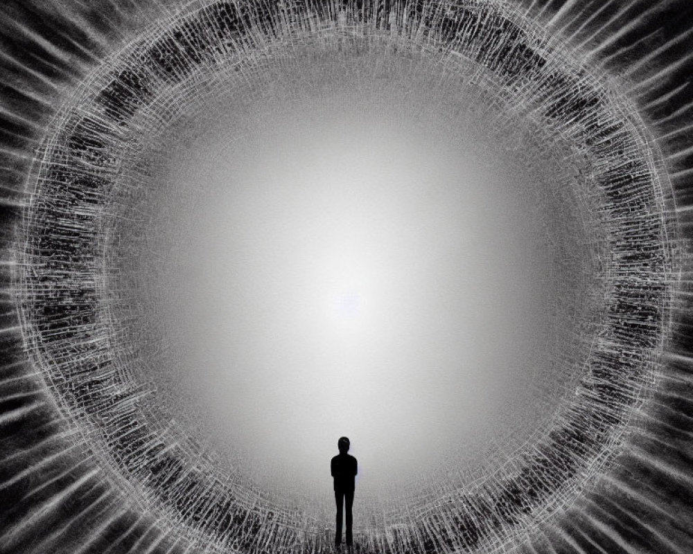 Silhouette of person in front of bright circular light with radiating lines