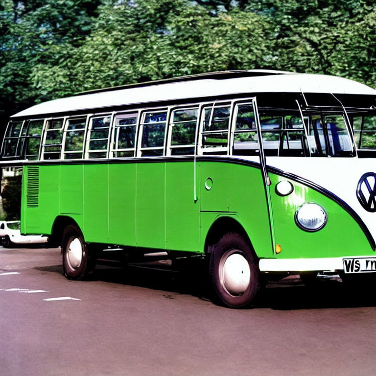 Vintage Green and White Volkswagen Bus Parked Among Lush Trees