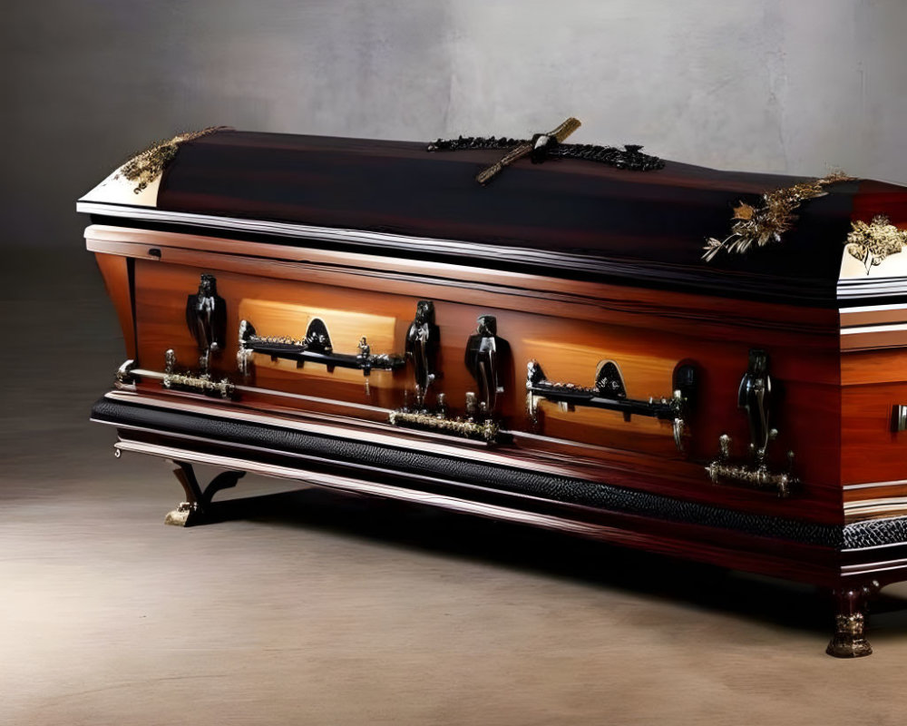 Polished wooden coffin with metal handles in dimly lit setting