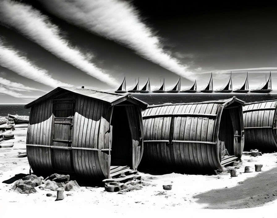 Dramatic black and white photo of overturned wooden boats on beach