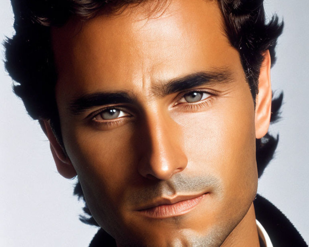 Close-Up Portrait of Man with Dark Curly Hair and Five O'Clock Shadow