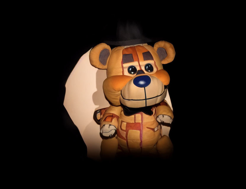 Cartoonish sheriff bear plush toy on black background