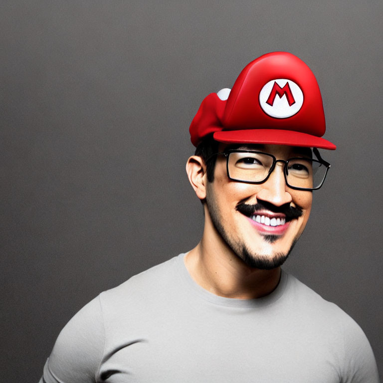 Person in Red Hat with 'M' Logo Smiling