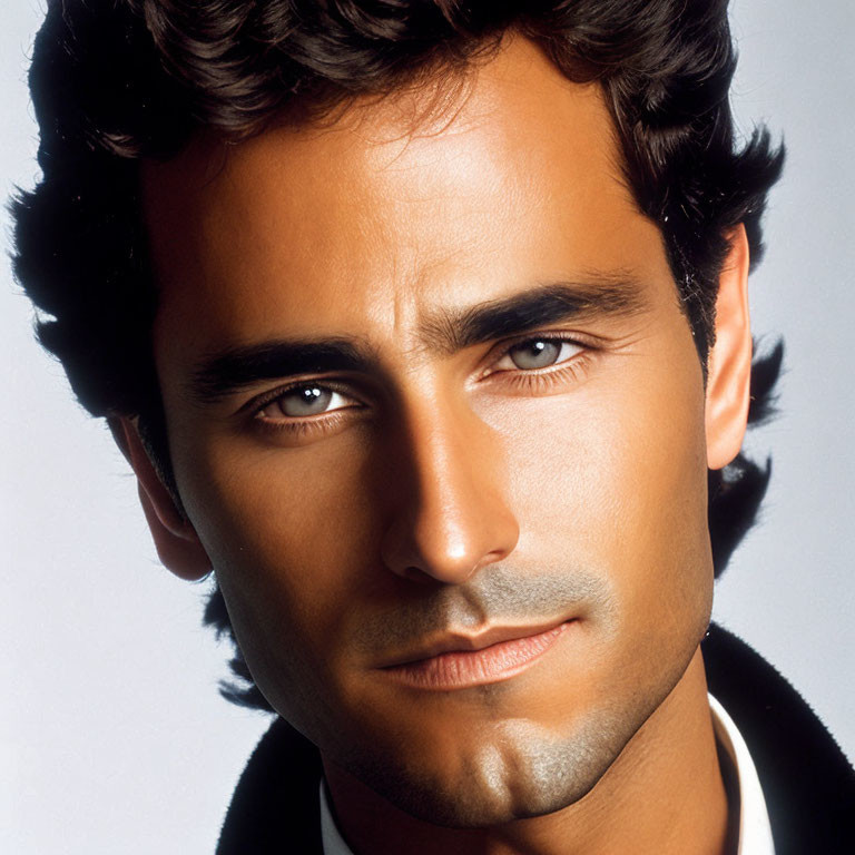 Close-Up Portrait of Man with Dark Curly Hair and Five O'Clock Shadow