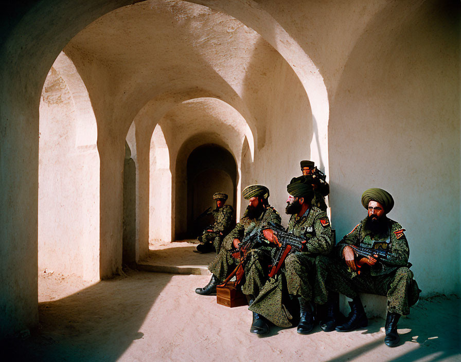 Soldiers in Turbans Holding Rifles in Arched Hallway