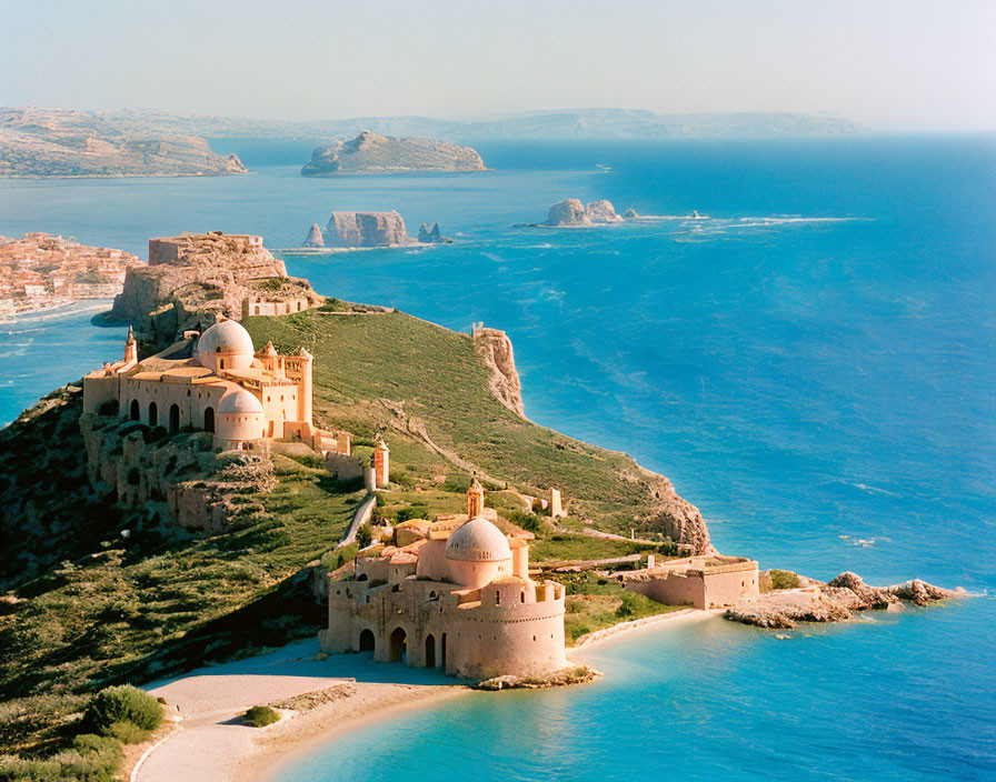 Historic fortress with domed structures overlooking serene blue sea