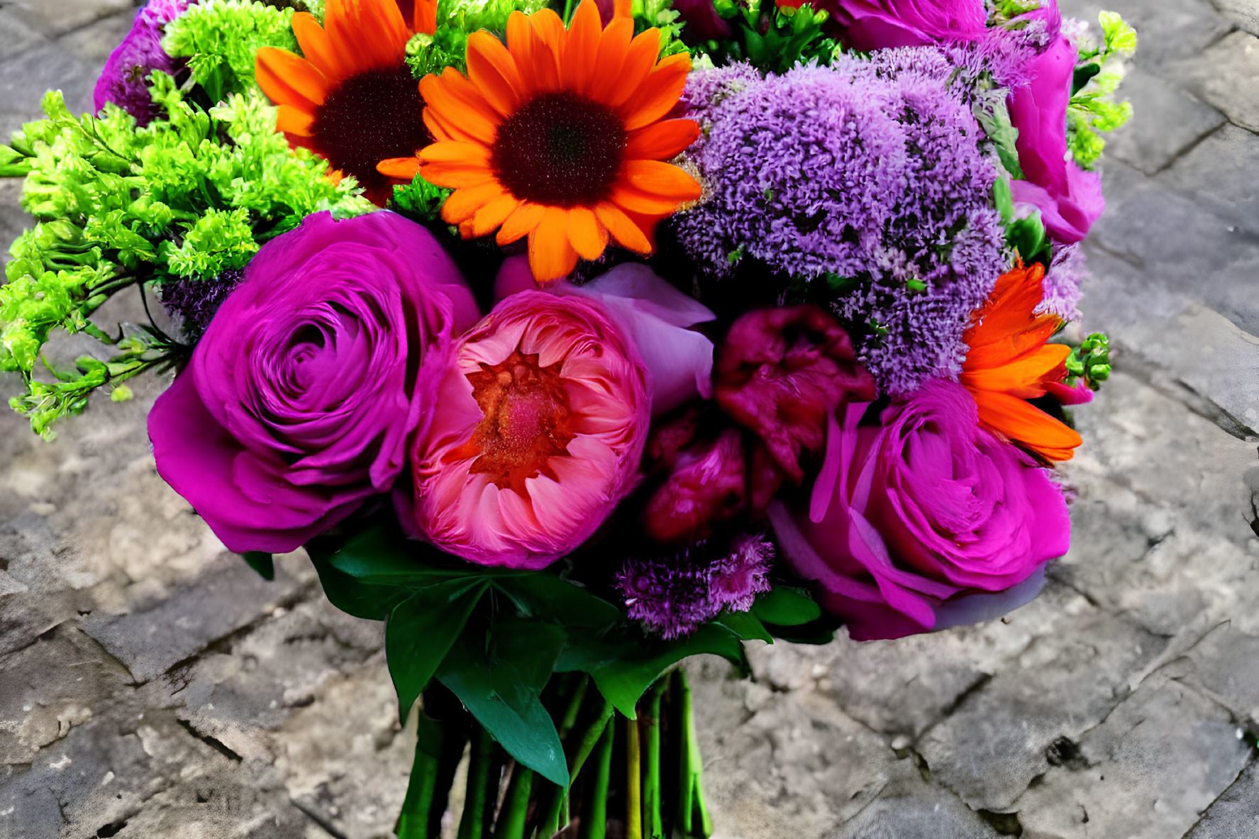 Colorful Bouquet of Purple Roses, Orange Gerberas, and Greenery on Cobblestone