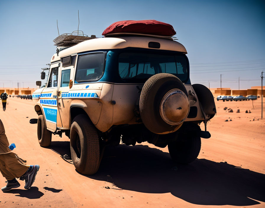 White Off-Road Vehicle with "Security" Sign, Blue Stripe, Parked on Sandy Terrain