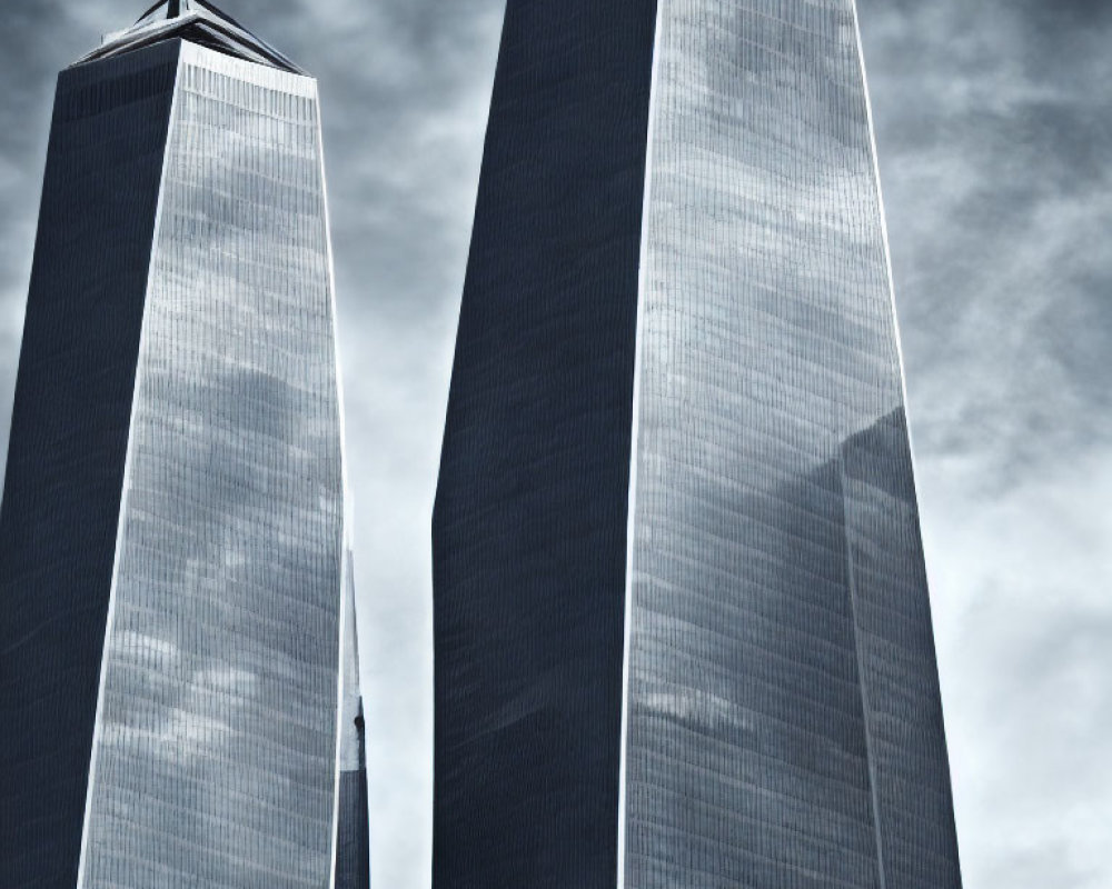 Twin skyscrapers with reflective glass facades under overcast sky