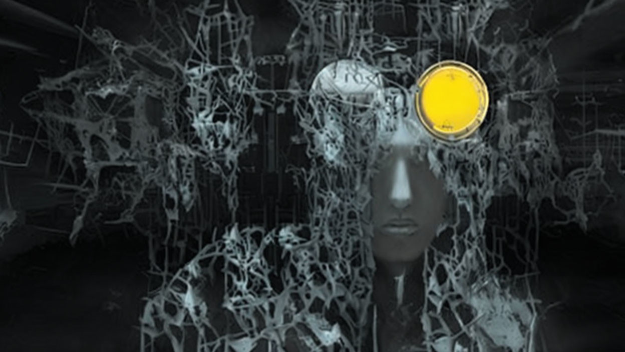 Person's face obscured by white fractal pattern, wearing yellow goggles on dark background