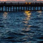 Vibrant sunset reflection on rippled sea surface in blue and orange gradient