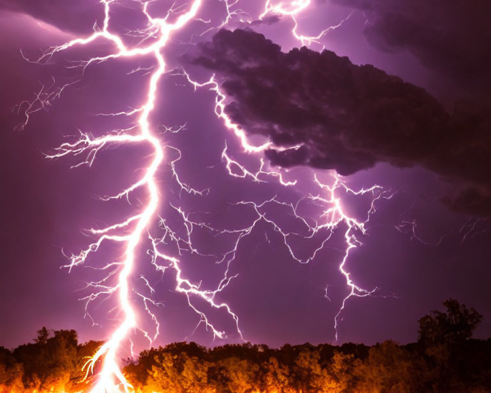 Dramatic lightning strike over glowing fire in night sky