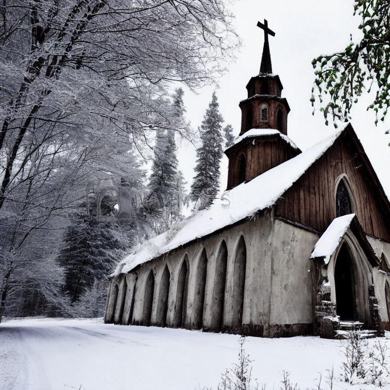 Snow-covered trees and wooden church with cross in winter scene