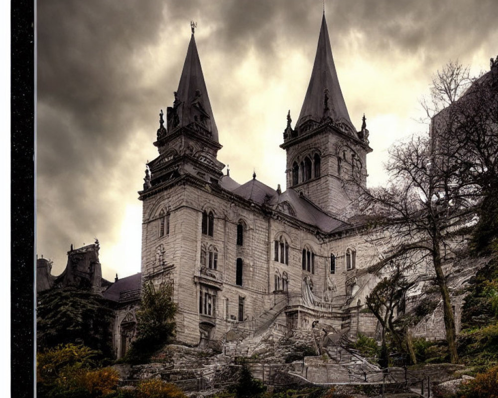 Gothic-style castle with twin spires under moody sky and stone stairway