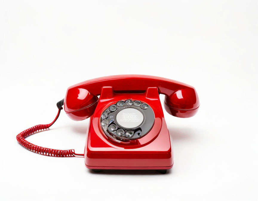 Vintage Red Rotary Dial Telephone on White Background