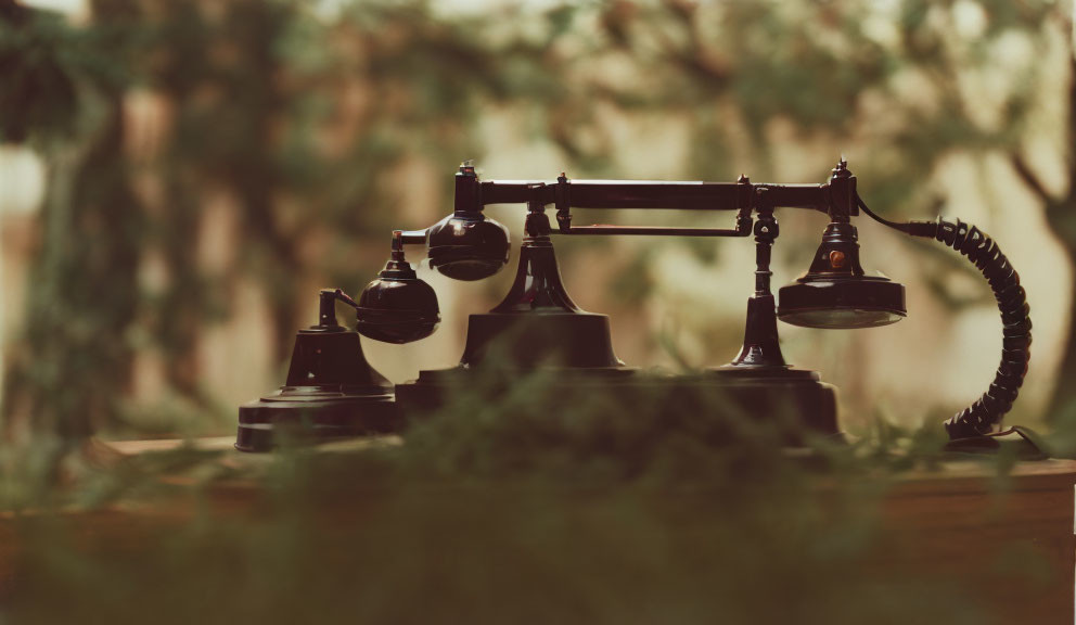 Vintage Candlestick Telephone with Rotary Dial on Wooden Surface