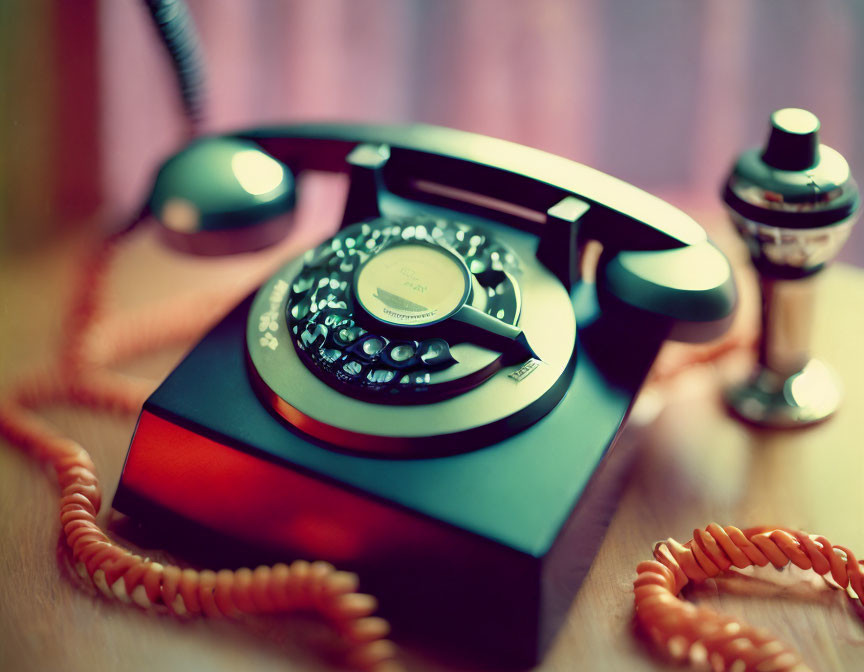 Vintage Black and Brown Rotary Telephone with Classic Microphone on Wooden Surface