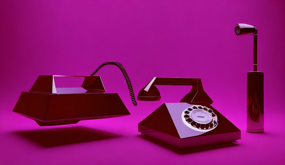 Vintage rotary phone and angular desk lamp on vibrant pink background