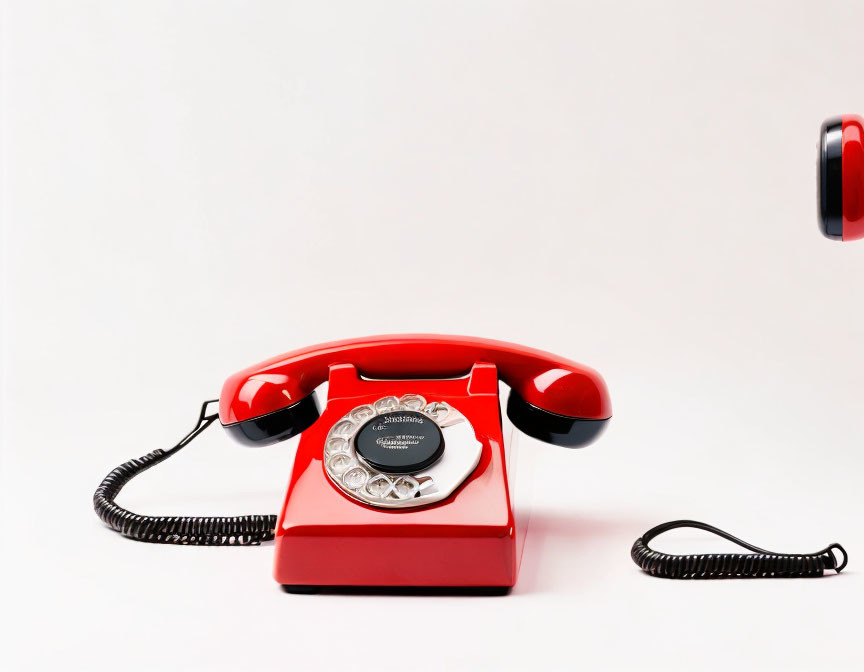 Vintage Red Rotary Dial Telephone Off Hook on White Background