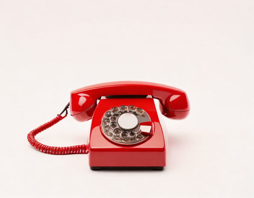 Vintage Red Rotary Phone Off Hook on White Background