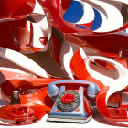 Vintage Red Rotary Phones with Tangled Cords on Striped Background