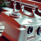 Vintage White Rotary Dial Telephone on Wooden Surface