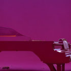 Child next to red grand piano in pink room