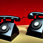 Vintage Black Rotary Telephones on Yellow Surface Against Red Background