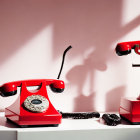 Vintage Red Rotary Telephone with Handset Off Hook in Dramatic Lighting