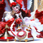 Digital artwork: Woman in red & white dress with feathery wings next to antique telephone