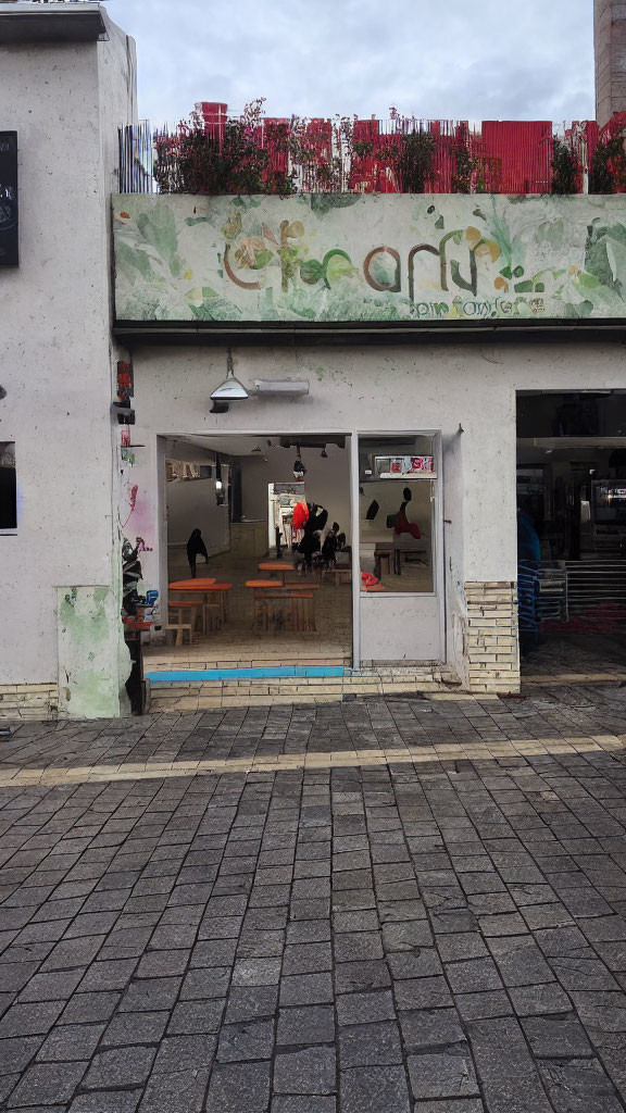 Graffiti-Covered Building Facade with Casual Interior and People