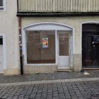 Graffiti-Covered Building Facade with Casual Interior and People