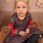 Digital artwork: Young girl with blonde curly hair and blue eyes in colorful dress and boots, against whims