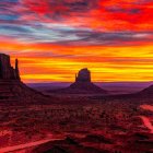 Dramatic red and orange sunset over Monument Valley's iconic landscape