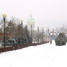 Snowy cityscape with vintage buildings and glowing lights in serene winter scene