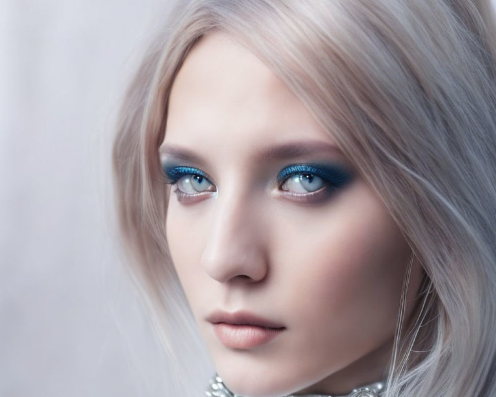 Close-Up Portrait of Person with Blue Eyes, Pale Skin, Pastel Hair, Silver Necklace